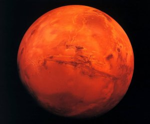 ARCHIV: Der Planet Mars mit dem 4000 Kilometer langen und 8 Kilometer tiefen Grabensystem Valles Marineris, 1980 fotografiert von der NASA Sonde VIKING Orbiter. Auf der Suche nach Leben auf dem Mars muss viel tiefer in die Oberflaeche des Planeten gebohrt werden als bisher gedacht. Das schliessen britische und Schweizer Wissenschaftler aus einer Analyse der auf den Planeten treffenden kosmischen Strahlung. Nach den Ergebnissen sind in zwei Metern Tiefe konservierte Zellen durch die Einwirkung der Strahlung nach etwa 450.000 Jahren nicht mehr lebensfaehig. Grosse Mengen Wasser und damit die Chance auf Leben auf der Marsoberflaeche gab es jedoch wohl nur bis vor einigen Milliarden Jahren. Bei kuenftigen Marsmissionen sollte daher entweder tief unter Eis oder in neu entstandenen Kratern nach Leben gesucht werden, wo sich die kosmische Strahlung noch nicht so dramatisch ausgewirkt habe, schlagen die Forscher um Lewis Dartnell vom University College London im Fachmagazin "Geophysical Research Letters" vor. (zu ddp-Text) Foto: Astrofoto/NASA/ddp